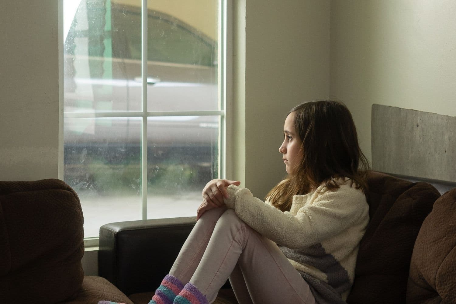 Enfant seul à une fenêtre