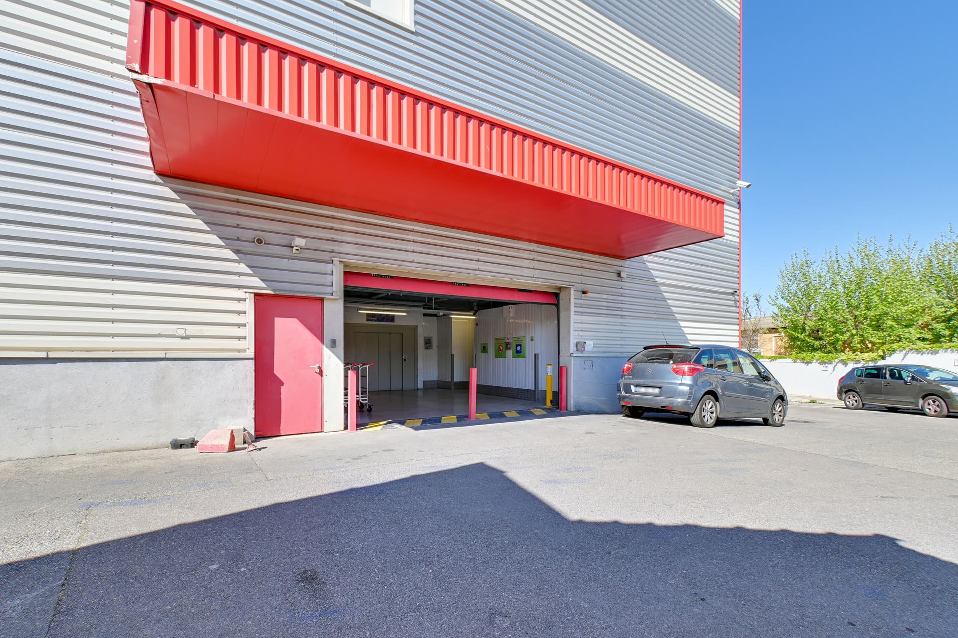 Entrée du parking avec auvent rouge et porte de garage menant au quai, HOMEBOX Marseille - Littoral, 173 chemin de la Madrague-Ville à Marseille