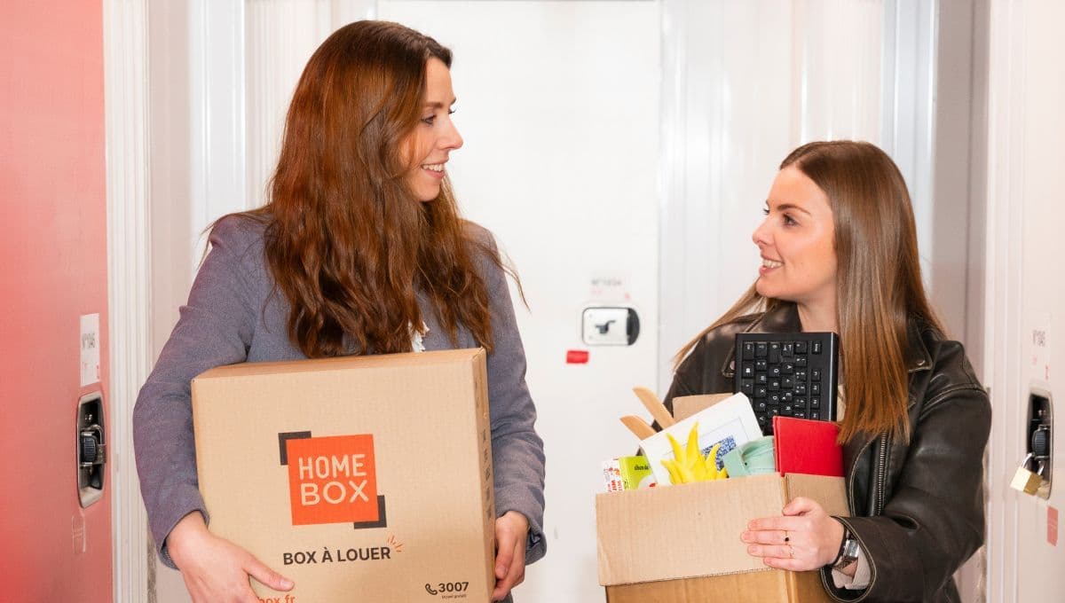 Deux étudiantes portant des cartons HOMEBOX dans un centre de garde-meubles